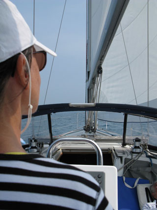 Anita from behind steering sailboat testimonial Anita from behind steering sailboat testimonial